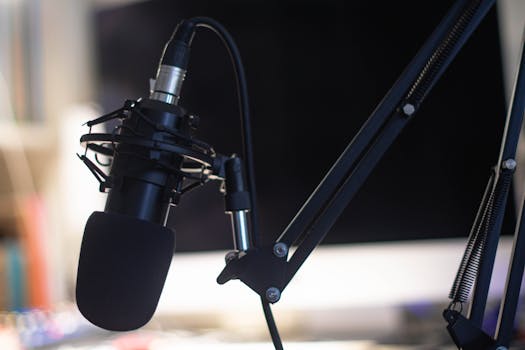 pexels-photo-4319926-4319926 Close-up of a condenser microphone in a studio setting, ideal for podcasts and audio recording.